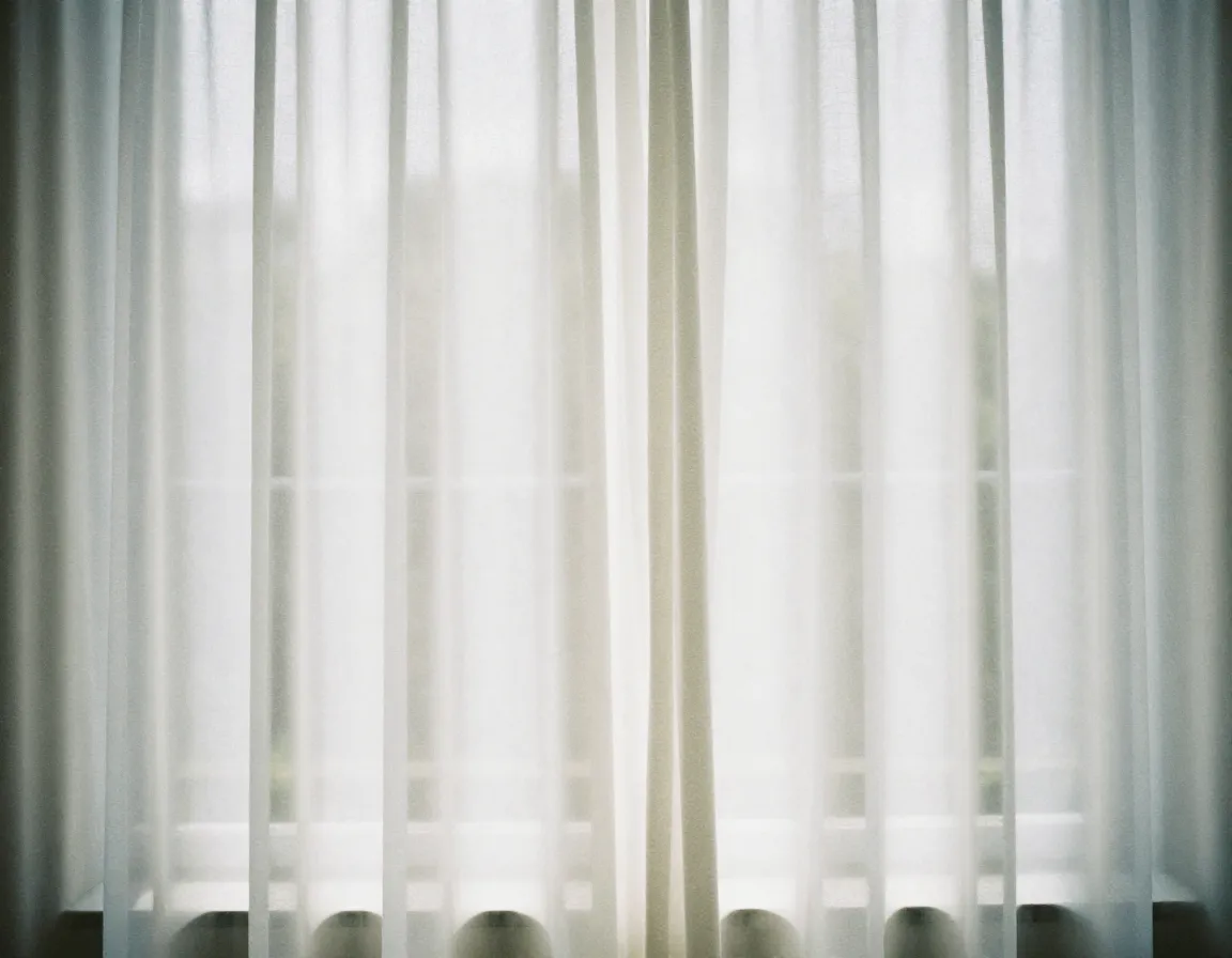 Sheer curtain panels allowing natural light diffusion